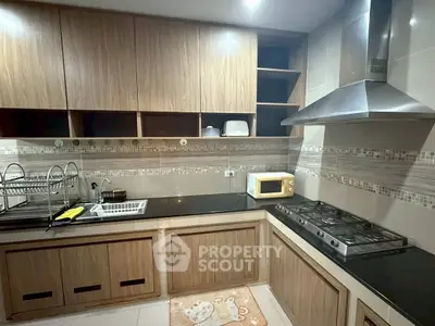 Modern kitchen with sleek wooden cabinets and built-in gas stove