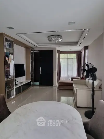 Spacious modern living room with elegant decor and large windows