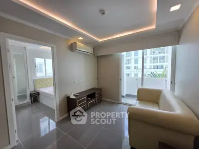 Modern living room with sleek design and balcony view in a stylish apartment.
