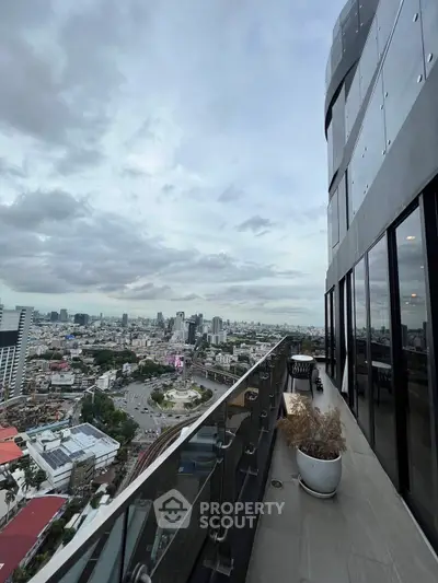 Stunning high-rise balcony with panoramic city view, perfect for urban living.