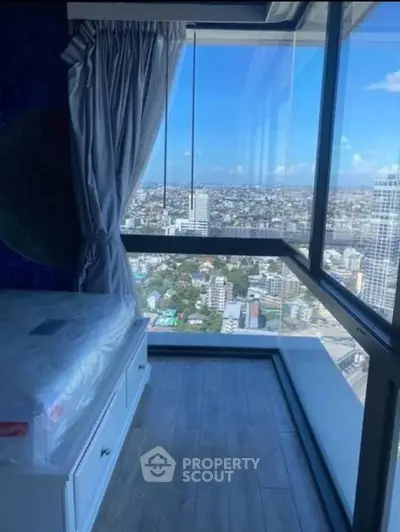 Stunning high-rise bedroom with panoramic city view and floor-to-ceiling windows.
