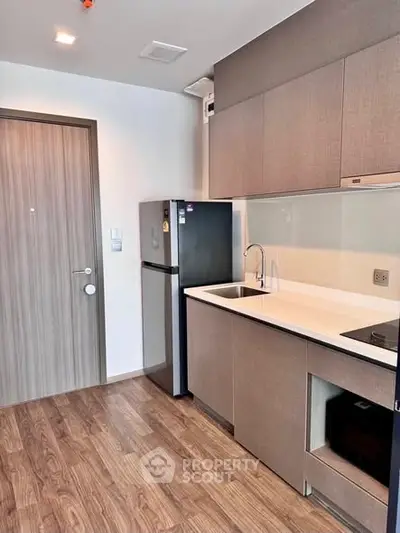 Modern kitchen with sleek cabinetry and built-in appliances in a stylish apartment.