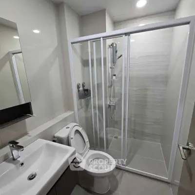 Modern bathroom with sleek shower enclosure and contemporary fixtures.