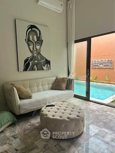 Luxurious living room with pool view, modern art, and elegant decor