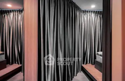 Luxurious bedroom with elegant floor-to-ceiling curtains and modern design.