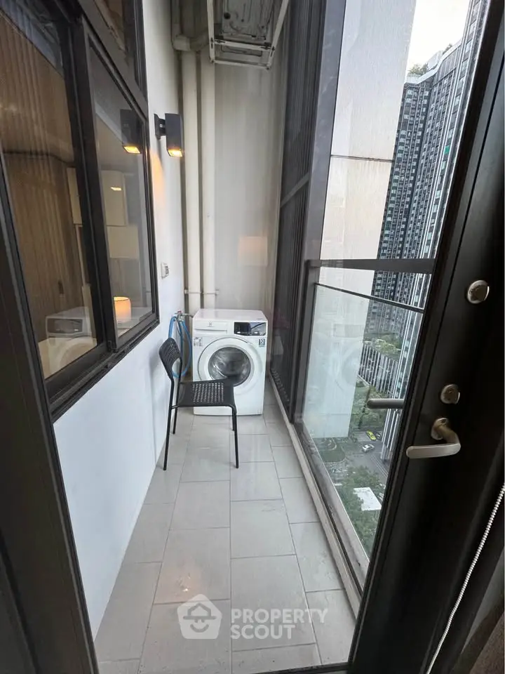 Compact balcony with washing machine and city view