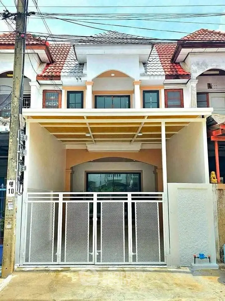 Charming townhouse with modern facade and gated entrance, perfect for urban living.
