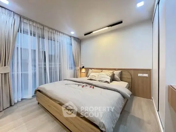 Modern bedroom with elegant design, featuring a cozy bed and stylish lighting, perfect for relaxation.