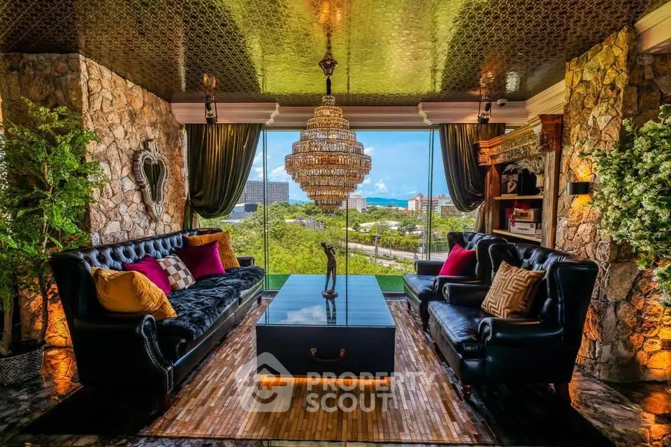 Luxurious living room with stunning view, elegant chandelier, and plush seating in a sophisticated setting.
