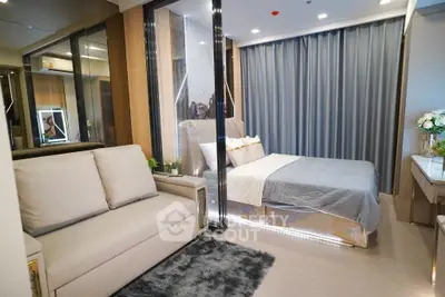 Luxurious modern bedroom with elegant decor and cozy seating area, perfect for relaxation and comfort.