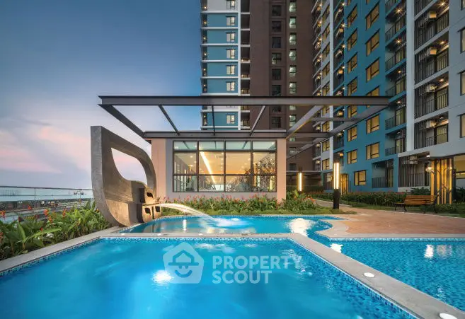 Luxurious apartment complex with stunning pool and modern architecture.