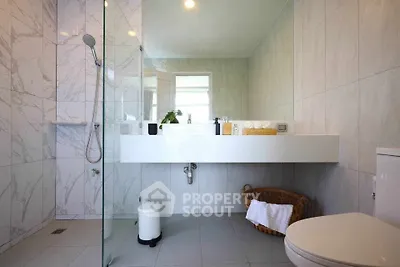 Luxurious modern bathroom with sleek design and elegant fixtures, featuring a spacious shower and stylish vanity.