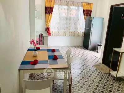 Charming dining area with stylish flooring and modern fridge in cozy apartment