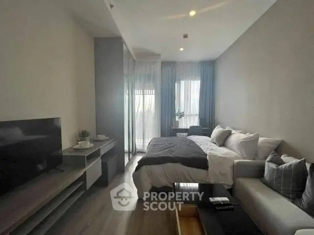 Modern studio apartment with cozy living area and natural light