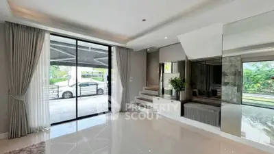 Spacious modern living room with large windows and elegant decor
