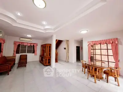 Spacious living room with elegant ceiling design and natural light