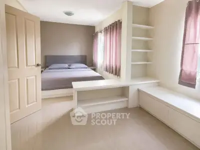 Spacious bedroom with built-in shelves and natural light