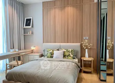 Modern bedroom with stylish decor and natural light, featuring a cozy bed and elegant wooden accents.