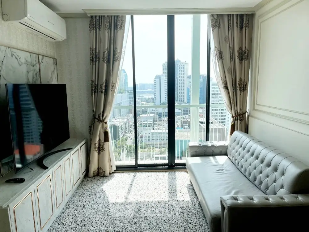 Luxurious living room with city view, elegant decor, and modern furnishings in high-rise apartment.