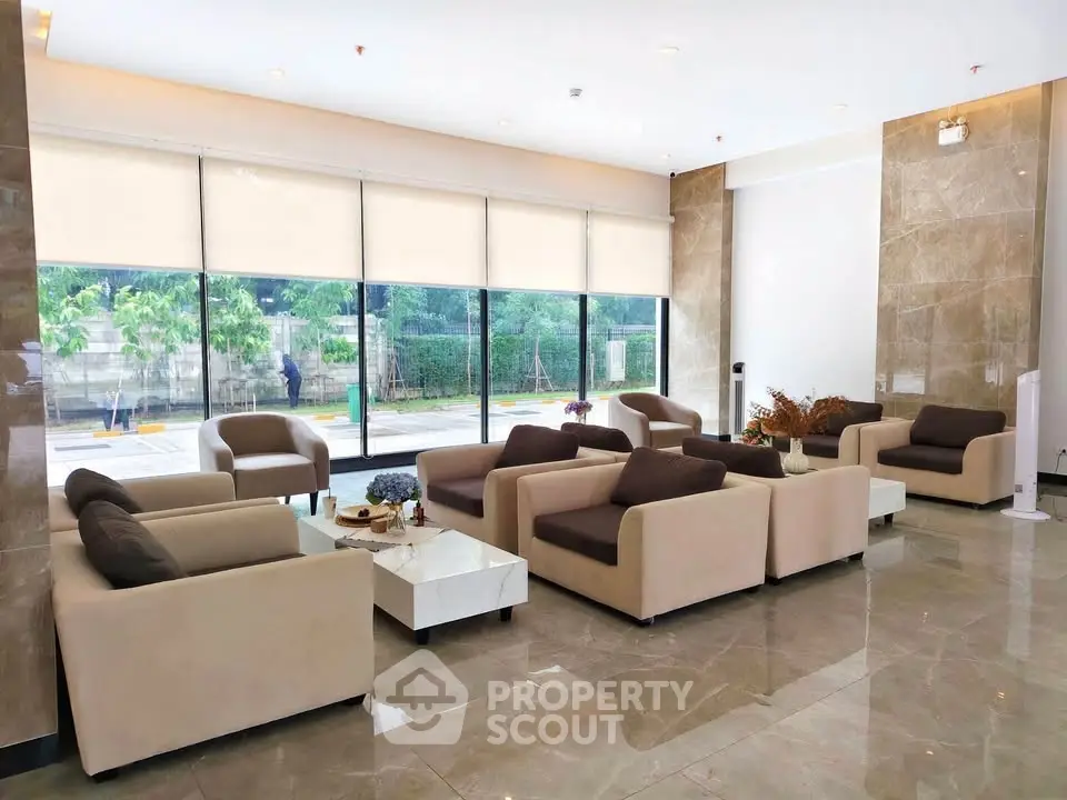 Luxurious lobby with modern seating and large windows offering garden views.