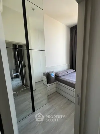 Modern bedroom with mirrored wardrobe and sleek design