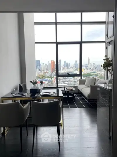 Modern living room with stunning city view, elegant dining setup, and floor-to-ceiling windows.