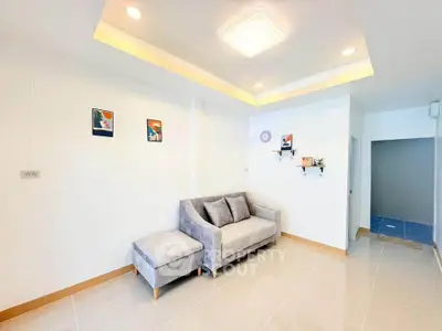 Modern living room with stylish gray sofa and decorative wall art