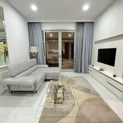 Modern living room with sleek furniture and glass coffee table