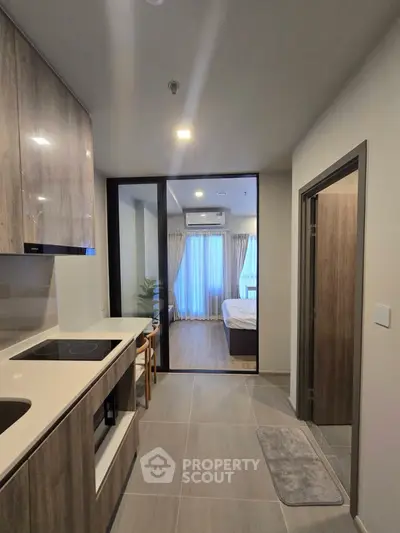 Modern apartment interior with sleek kitchen and cozy bedroom view