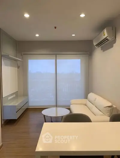 Modern living room with sleek furniture and natural light, perfect for cozy relaxation.