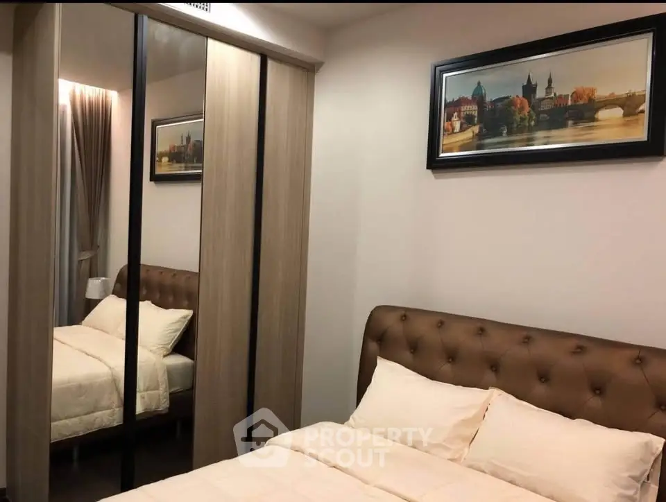 Cozy bedroom with mirrored wardrobe and elegant decor