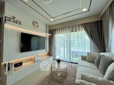 Luxurious living room with modern decor, large TV, and elegant curtains, perfect for relaxation and entertainment.