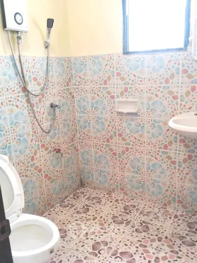 Charming bathroom with colorful mosaic tiles and modern fixtures.