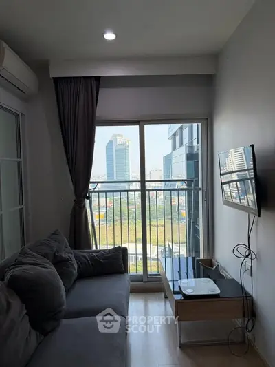 Modern living room with city view, cozy sofa, and wall-mounted TV in a high-rise apartment.