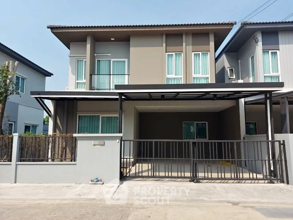 Modern two-story house with spacious driveway and contemporary design.