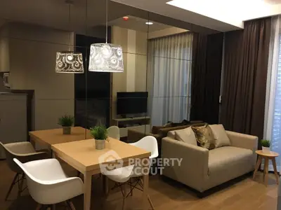 Modern living room with stylish decor, cozy sofa, and elegant dining area in a contemporary apartment.