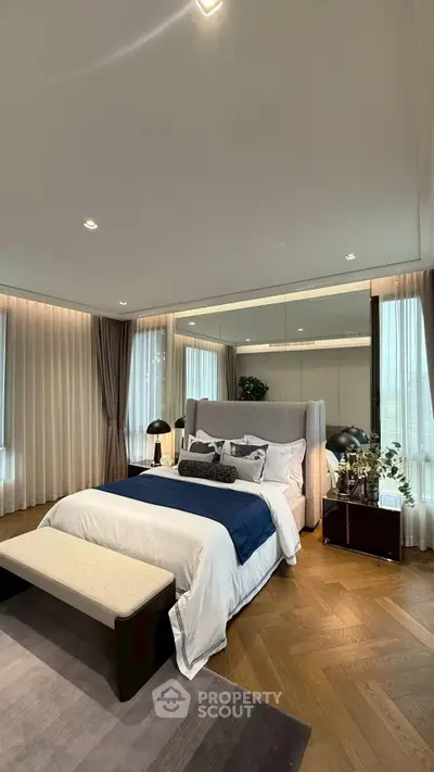 Luxurious bedroom with elegant decor and large windows for natural light