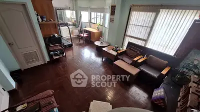 Spacious living room with hardwood floors and ample natural light