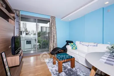 Modern living room with balcony access and stylish decor in urban apartment.