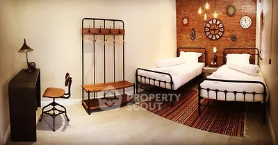 Charming industrial-style bedroom with twin beds and vintage decor accents.