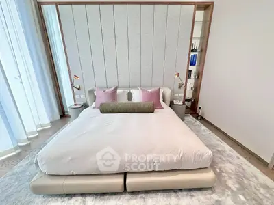 Luxurious modern bedroom with elegant decor and plush bedding in a high-end apartment.