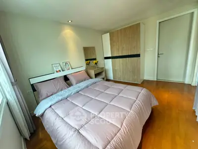 Cozy bedroom with modern decor and ample natural light