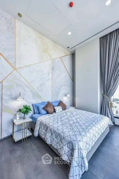 Luxurious bedroom with modern decor and stunning city view, featuring elegant lighting and stylish bedding.