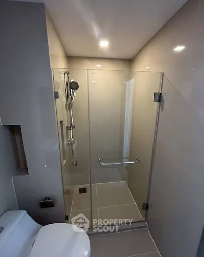 Modern bathroom with glass shower enclosure and sleek fixtures
