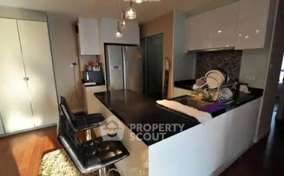 Modern kitchen with sleek black countertops and stylish bar stools