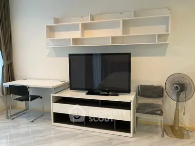 Modern living room with sleek TV stand, wall shelves, and minimalist desk setup.