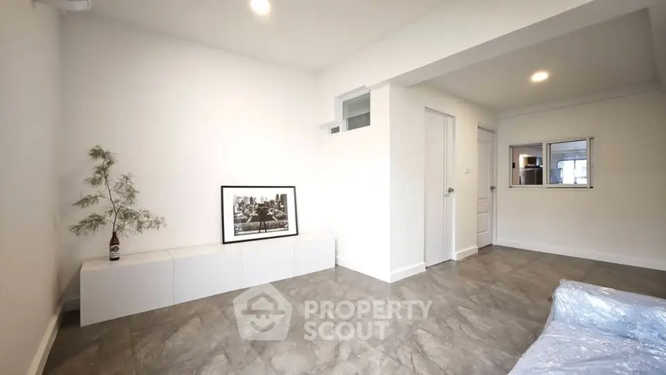 Spacious modern living room with minimalist decor and sleek flooring