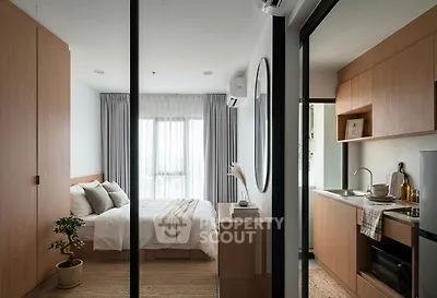 Modern studio apartment with cozy bedroom and compact kitchen