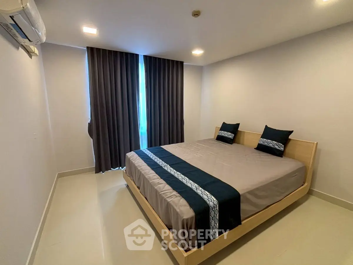 Spacious bedroom with modern decor and large bed in a stylish apartment.