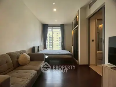 Modern studio apartment with cozy living area and large window view